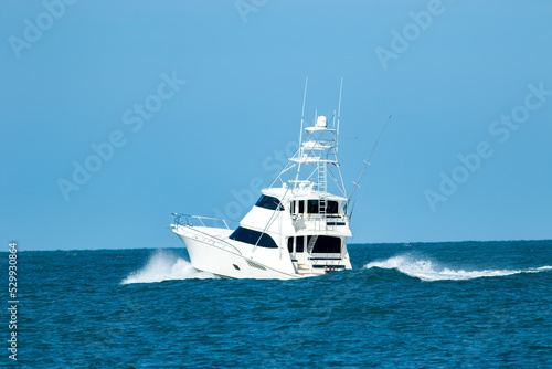 A sportfish motor yacht heads out to sea for a fishing trip