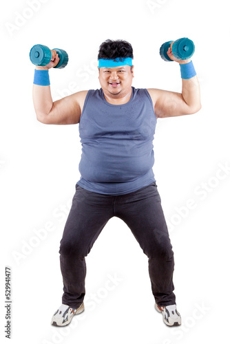 Happy fat man exercise with two dumbbells on studio