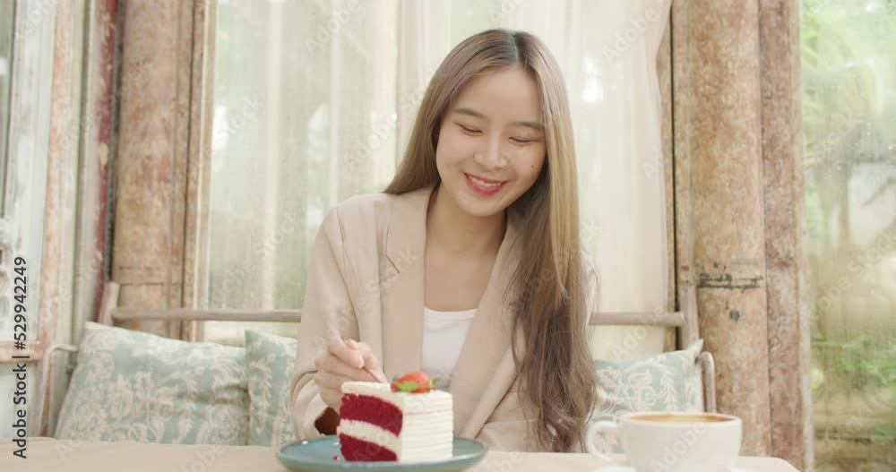 Close up POV beautiful smiling asian woman looking camera on romantic date eating sweet dessert at cafe. Attractive satisfied young girl feeling pleasure with delicious food cake at cozy coffeeshop. Close up POV beautiful smiling asian woman looking camera on romantic date eating sweet dessert at cafe. Attractive satisfied young girl feeling pleasure with delicious food cake at cozy coffeeshop.