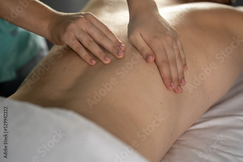 Close up of unrecognizable man having full body massage at male spa. female therapist rubbing man shoulders, making relaxing massage. massage, cosmetology for men
