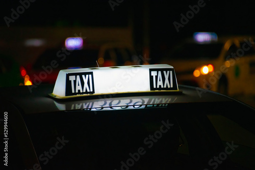 Taxi sign lit on dark background