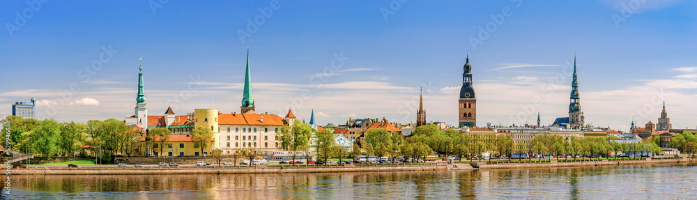 Panoramic view across river of old town in Riga, Latvia with copy space in sky.