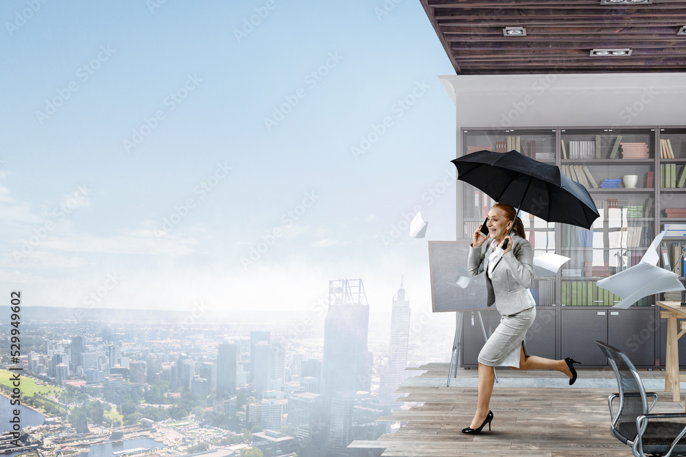 Businesswoman running with umbrella . Mixed media Businesswoman running with umbrella . Mixed media