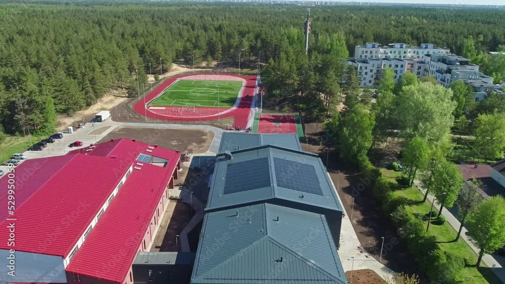 Drone flyover Building complex with solar panels on rooftop, Soccer ...