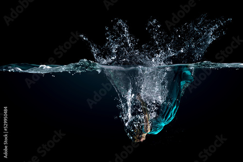 Girl in green dress under water