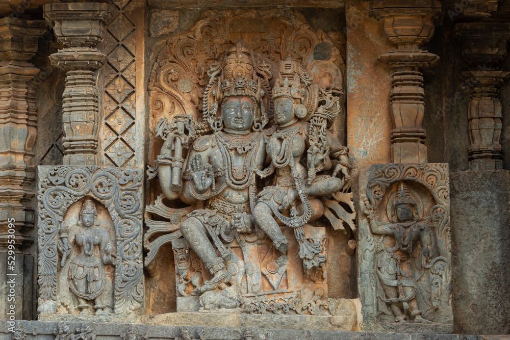 The Sculpture of Lord Shiva and Parvati on the Hoysala Temple, Halebeedu, Karnataka, India.