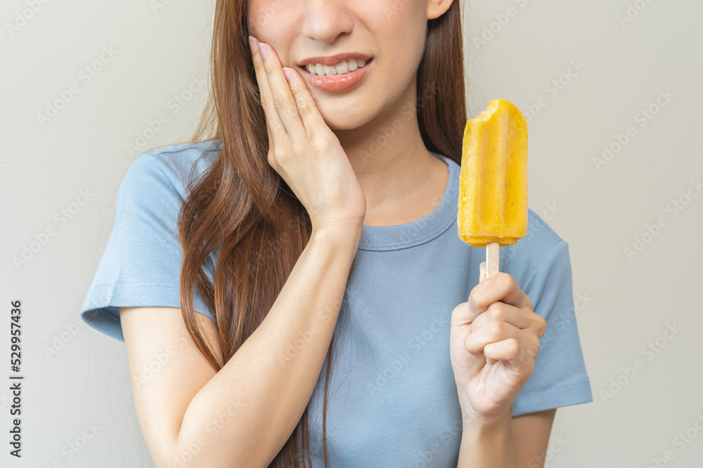 Face expression suffering from sensitive teeth and cold, asian young