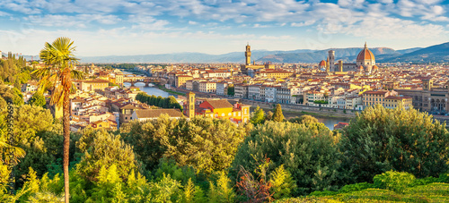 Panoramic view of Arno river, with Ponte Vecchio, Palazzo Vecchio and Cathedral of Santa Maria del Fiore at sunrise in Florence, Italy. Architecture and landmark of Florence.
