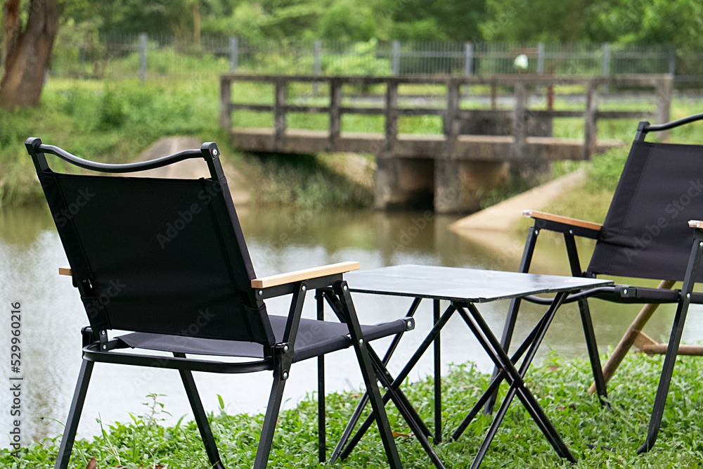 Couple chairs at terrace in the morning time and beautiful scenery of the canal and green forest. Relaxing corner. Couple chairs at terrace in the morning time and beautiful scenery of the canal and green forest. Relaxing corner.