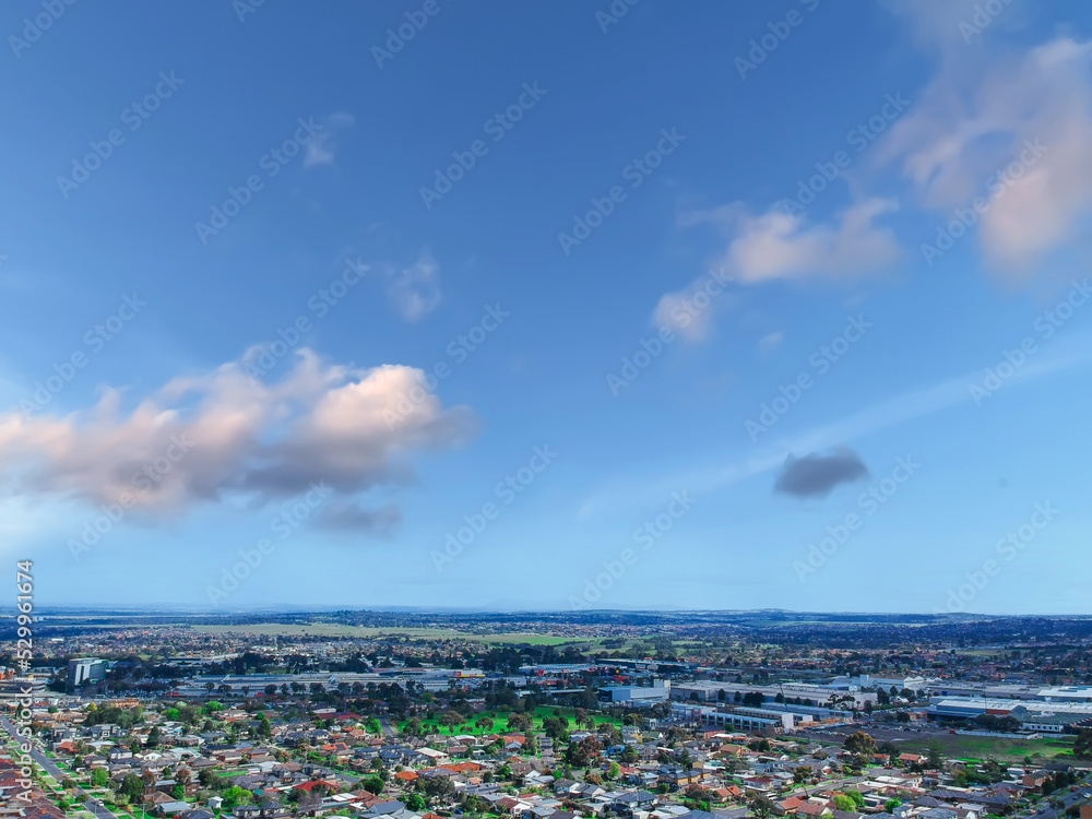 Fototapeta premium Panoramic aerial Drone view of Melbournes suburbs and CBD looking down at Houses roads and Parks Victoria Australia. Beautiful colours at Sunset