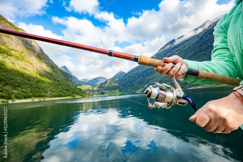 Tela Woman fishing on Fishing rod spinning in Norway.