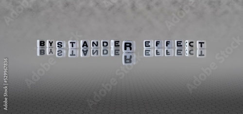 bystander effect word or concept represented by black and white letter cubes on a grey horizon background stretching to infinity
