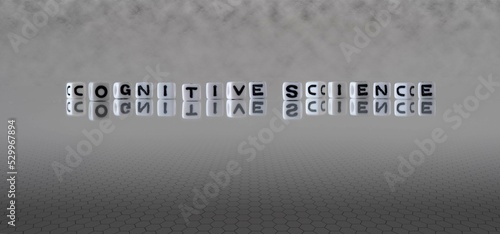 cognitive science word or concept represented by black and white letter cubes on a grey horizon background stretching to infinity