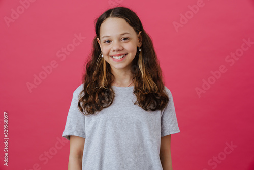 Tableau sur toile White preteen girl wearing t-shirt smiling and looking at camera