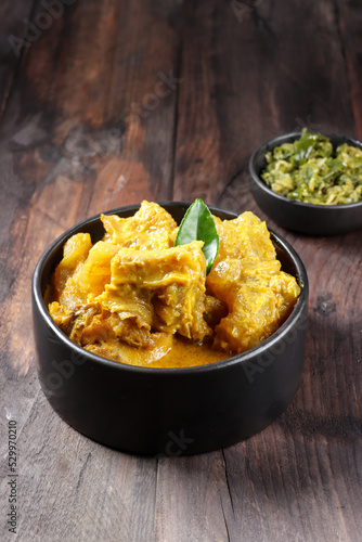 Gulai Tunjang or Kikil or Gulai Kaki Sapi is a popular spicy cow's trotter curry in Padang (West Sumatra-Indonesia) cuisine. Food preparation for the feast of Eid al-Fitr and Eid al-Adha photo