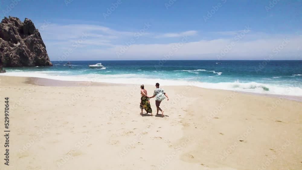 aerial drone view of a couple running and kissing passionately by the beach in Cabo San Lucas, Baja California. romantic beach like in paradise, mexico. 4K videos. aerial drone view of a couple running and kissing passionately by the beach in Cabo San Lucas, Baja California. romantic beach like in paradise, mexico. 4K videos.