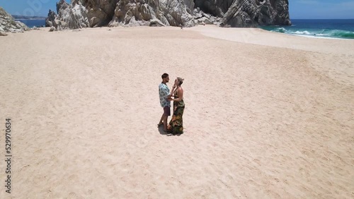 aerial drone view of a couple kissing passionately by the beach in Cabo San Lucas, Baja California. romantic beach like in paradise, mexico. 4K videos.