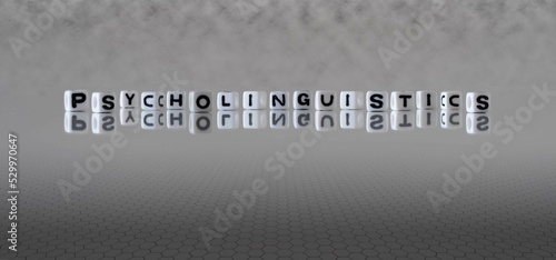 psycholinguistics word or concept represented by black and white letter cubes on a grey horizon background stretching to infinity