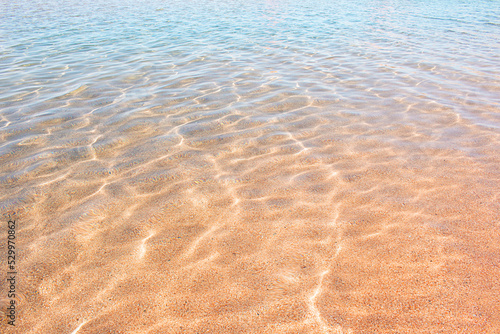 Sea water with highlights and ripples. Ocean or lake shore. Sunny day. Rest  travel. Copy space