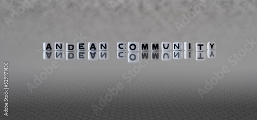 andean community word or concept represented by black and white letter cubes on a grey horizon background stretching to infinity