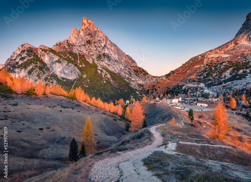 Winding trek to Falzarego pass with Forcella and Sass de Stria peaks on background. Superb autumn scene Dolomite Alps, Cortina d'Ampezzo lacattion, Italy, Europe. Beauty of nature concept background.