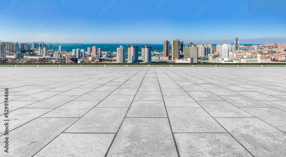 Empty floor tiles and city buildings background