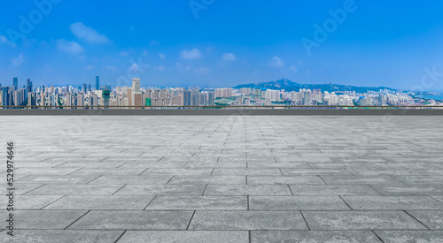 Empty floor tiles and city buildings background
