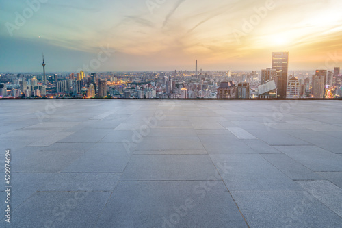 Empty floor tiles and city buildings background