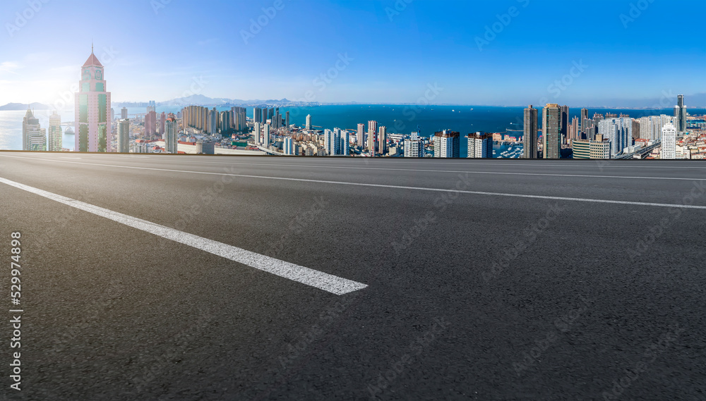 Fototapeta premium Empty road and city buildings background
