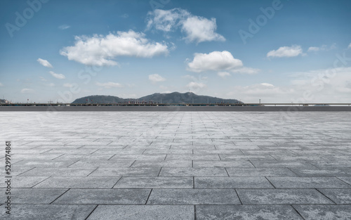 Empty floor tiles and city buildings background © 昊 周