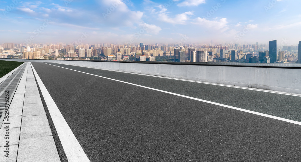 Empty road and city buildings background Empty road and city buildings background