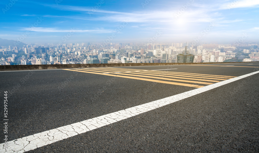 Fototapeta premium Empty road and city buildings background