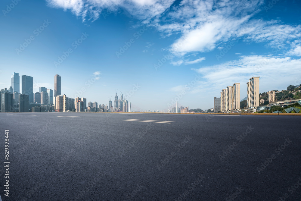 Empty road and city buildings background Empty road and city buildings background
