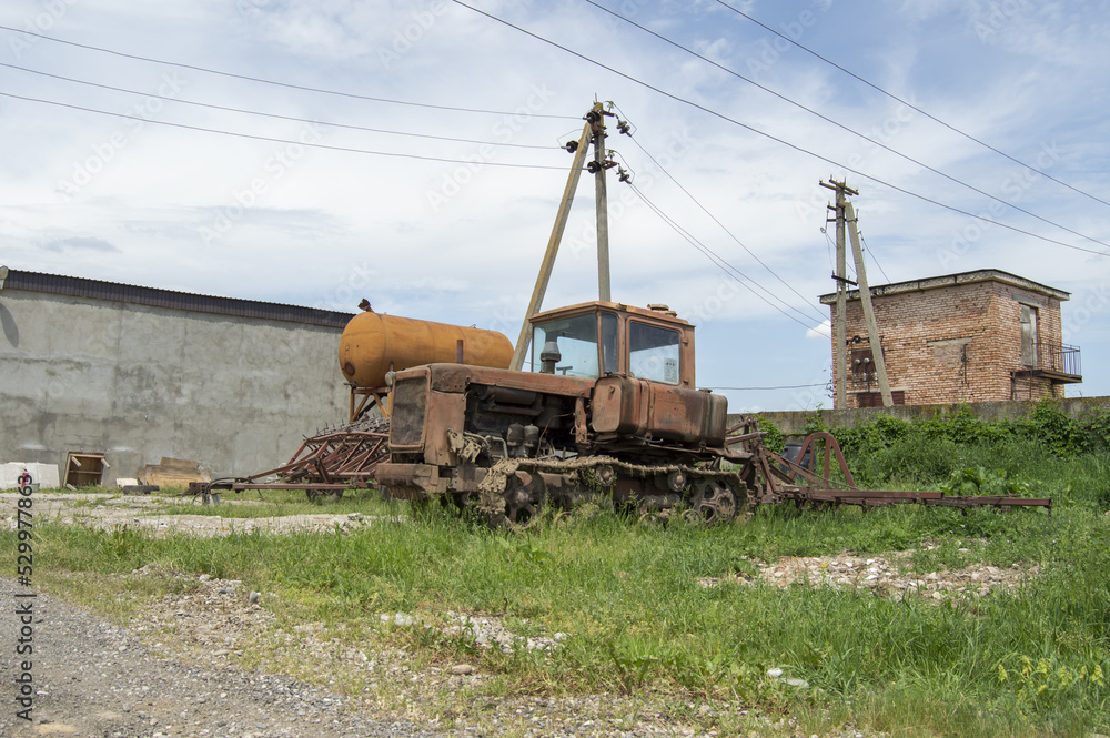 Old broken tractor heavily rusted, old agricultural machinery