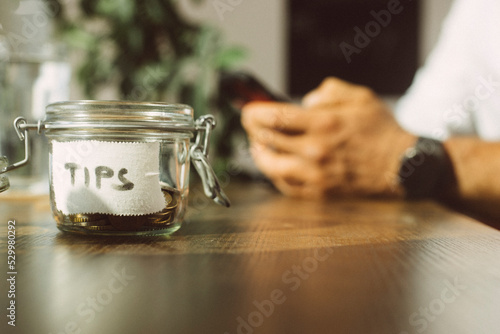Tip jar on table at coffee shop