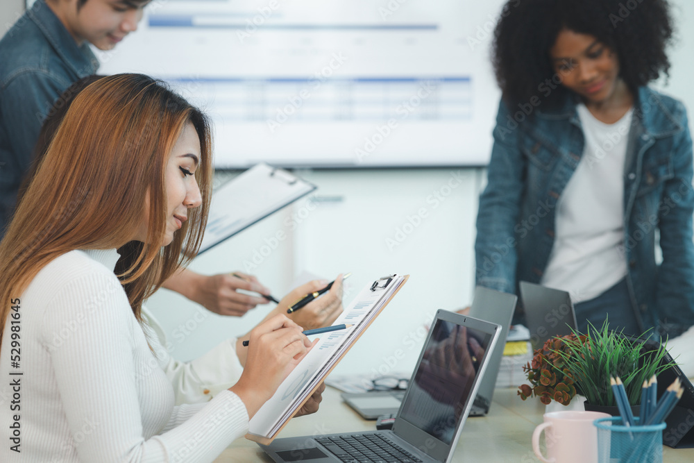 Close-up shot of a woman meeting in a startup company meeting room, she is a marketing worker attending meetings with executives and employees to plan a sales boost. Sales management concept. Close-up shot of a woman meeting in a startup company meeting room, she is a marketing worker attending meetings with executives and employees to plan a sales boost. Sales management concept.