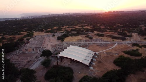 Aerial drone footage of archaeological site of Apollon Hylates sanctuary in Limassol, Cyprus. 360 orbital sunset view of ruins of ancient Greek temple of pagan god Apollonas Ylatis, Kourio, from above photo