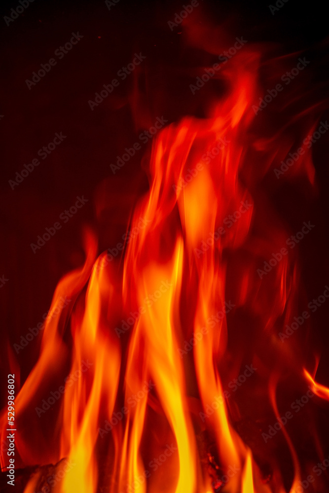 Bright fire burning with ash in fireplace Bright fire burning with ash in fireplace