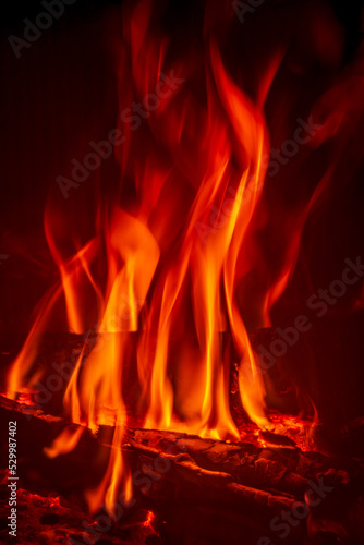 Bright fire burning with ash in fireplace