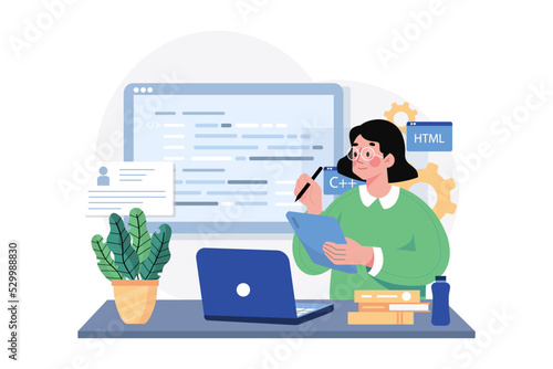 Young female computer programmer coding at laptop