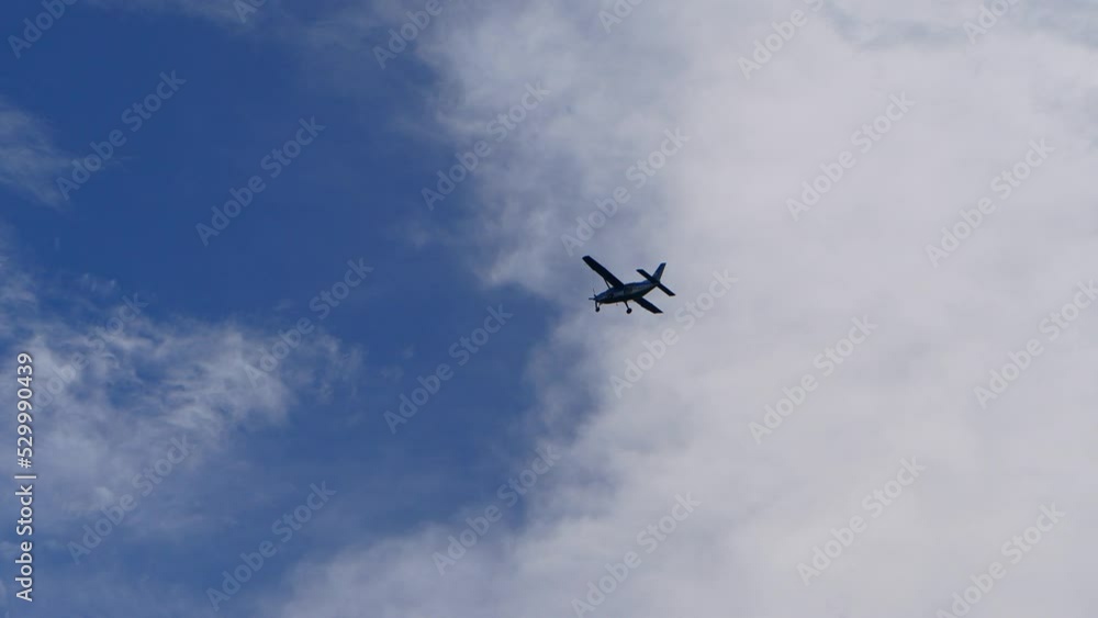 private airplane flying fast above clouds and blue sky. private airplane flying fast above clouds and blue sky.