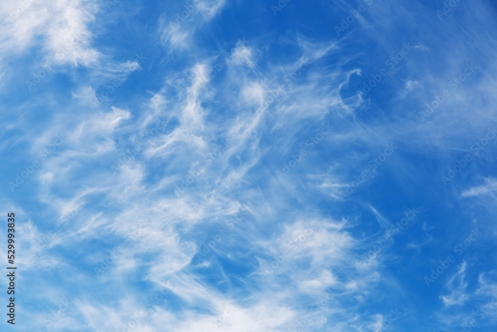 Blue sky natural background. White clouds in the blue sky Blue sky natural background. White clouds in the blue sky