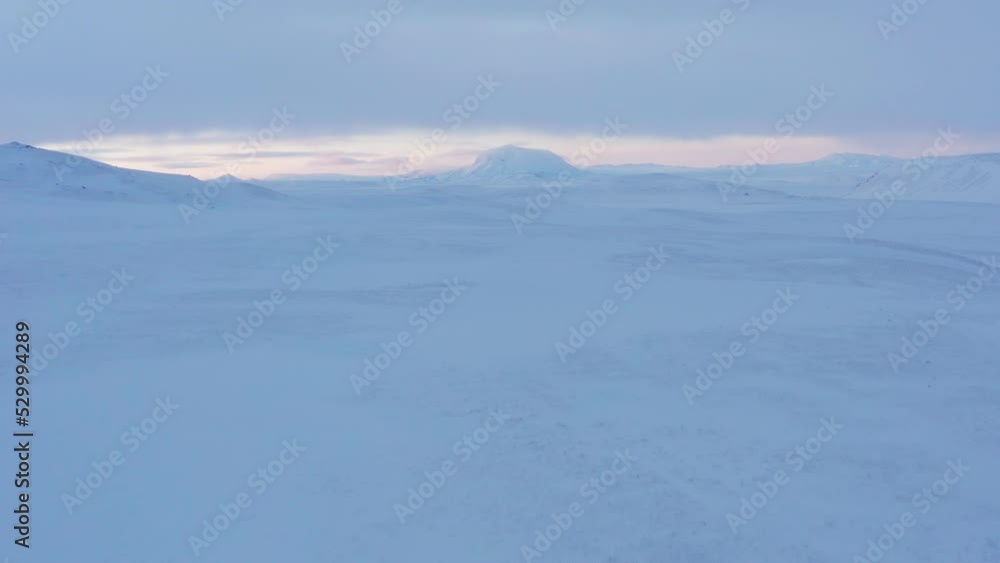 Drone Pilot In Snow Covered Landscape Towards Pink Clouds Drone Pilot In Snow Covered Landscape Towards Pink Clouds