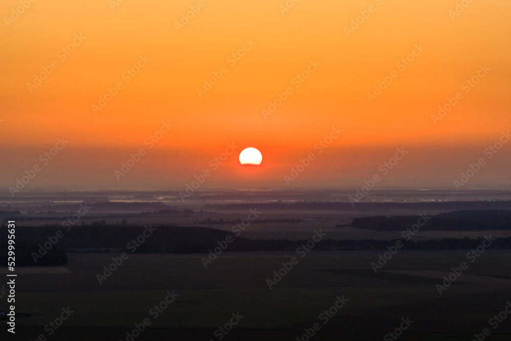red sun of sunrise or sunset in the early morning or evening
