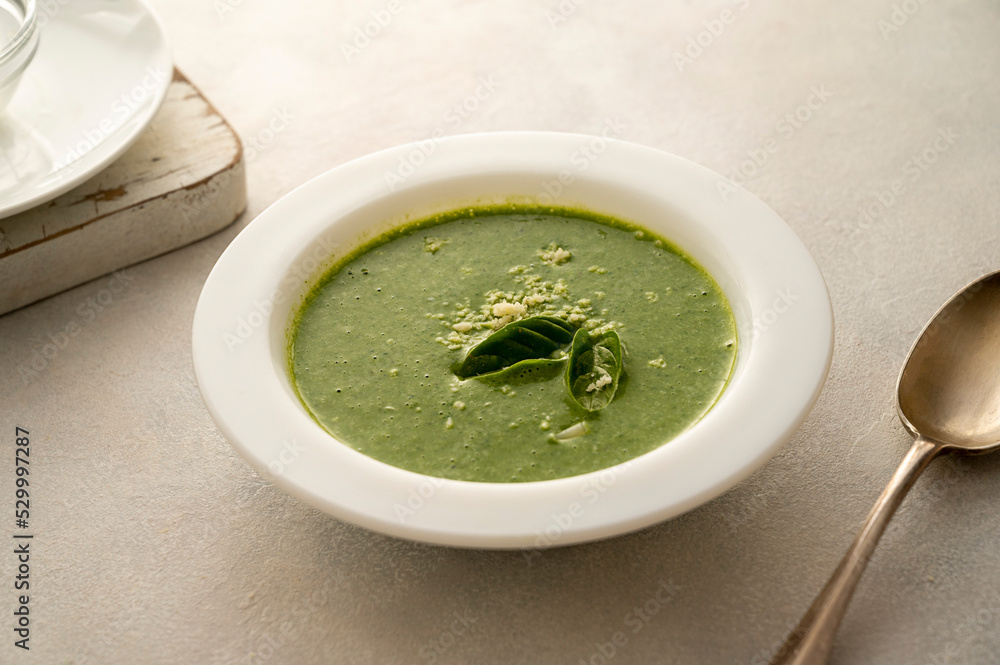 Spinach soup. Green creamy, vegan creamy soup on bright background Spinach soup. Green creamy, vegan creamy soup on bright background