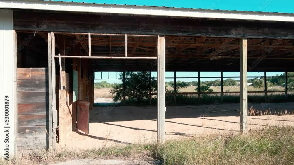 Slow pan of the outside of abandoned stables. Slow pan of the outside of abandoned stables.