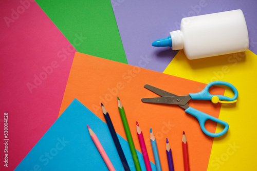 preschool art lesson background - colorful paper, pencils, glue and scissors photo