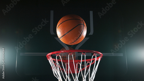 Detail of basketball ball hitting the basket. #530004064