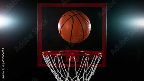 Detail of basketball ball hitting the basket. © Jag_cz