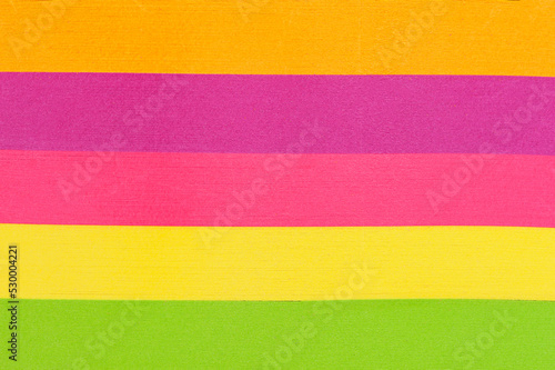 Multicolored paper background, yellow, pink, green